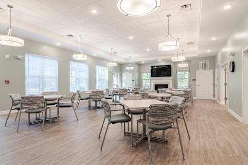 a large dining room with tables and chairs and a fireplace at Sweetwater Point in Douglasville, GA