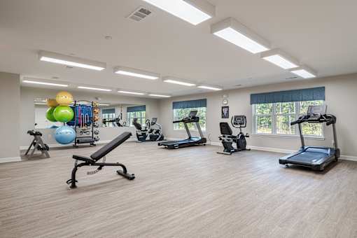 a gym with cardio machines and weights at Sweetwater Point in Douglasville, GA