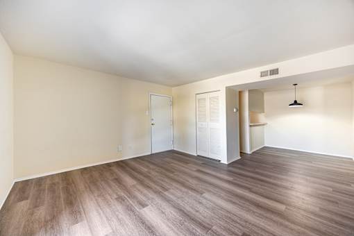 A room with wood flooring and white walls.