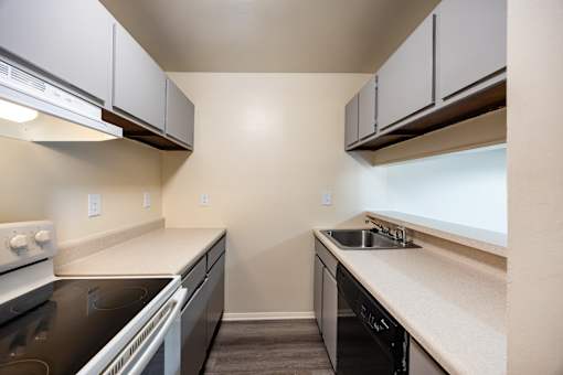 A kitchen with black countertops and white appliances.