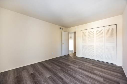 A room with a wooden floor and white walls.