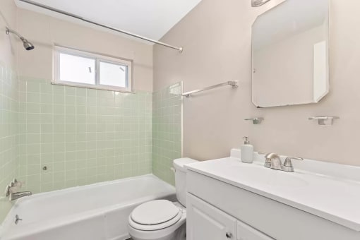 a bathroom with a sink toilet and a bath tub