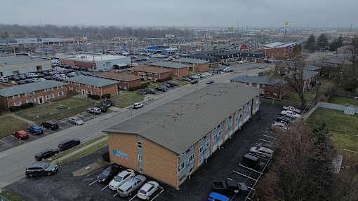 A parking lot with a building in the middle.