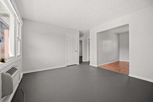 A room with white walls and a wooden floor.