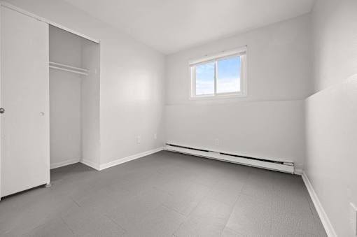 A room with a window and a door.