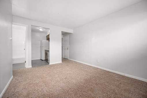 A room with a carpeted floor and white walls.