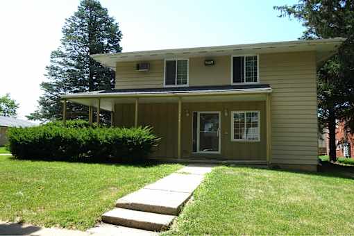 A house with a green lawn and a white door.