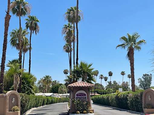 A street with palm trees and a sign that says "Welcome to Sunnyvale".