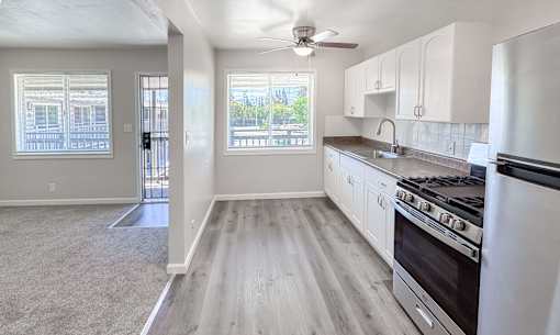 Willow Manor 1bed 1 bath floorplan - living room and kitchen separated by a half wall with windows in both rooms