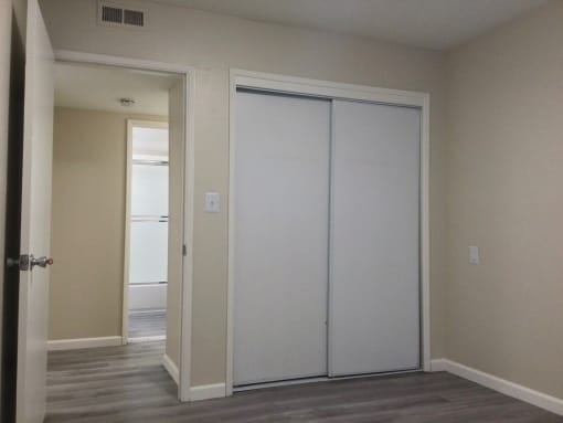 Bedroom with two white closet doors