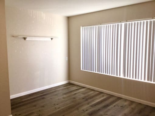 Bedroom room with a large window and wood floors