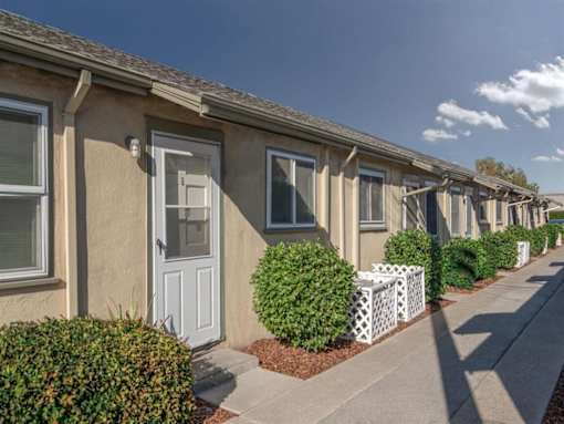 Chestnut and Hedding Apartments Building with a sidewalk and shrubs