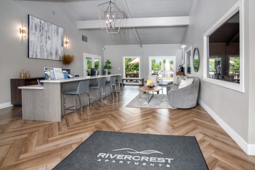 Leasing office with furniture and large windows at Rivercrest Apartments, Sacramento, CA 