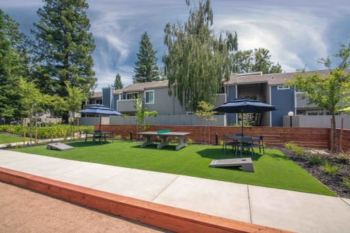 Resident courtyard with outdoor games and furniture at Willow Grove Apartments, Sacramento, CA