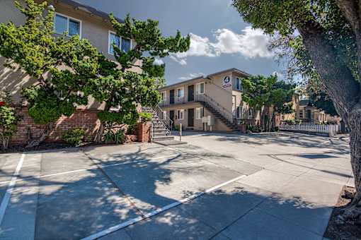 4th street Apartment building with sidewalk and trees