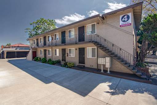 4th Street Apartments 2 story building with the logo sign on it