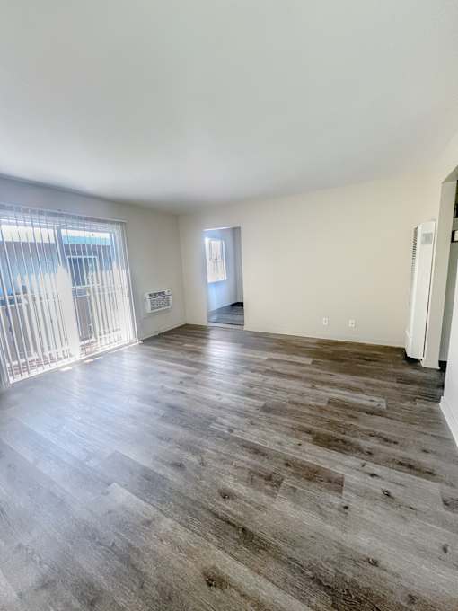 Monterey Manor Vacant Apartment Living Room with vinyl plank flooring and a patio glass door