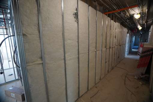 A room under construction with insulation on the walls.