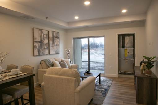 A living room with a dining table and chairs.
