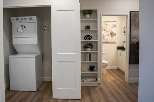 A small white kitchen with a fridge and a cabinet.