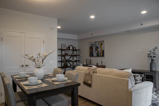 A dining table with chairs and a couch in a room.