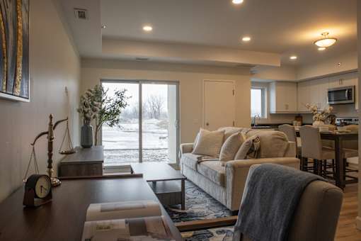 A living room with a couch, a coffee table, and a TV.