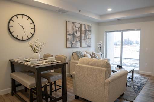 A living room with a dining table and chairs.