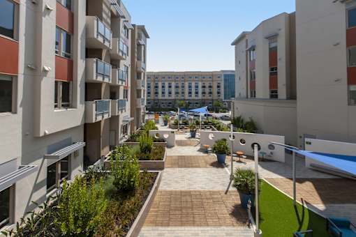A sunny day in a courtyard surrounded by buildings.