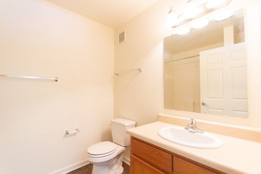 A white toilet sits next to a sink in a small bathroom.
