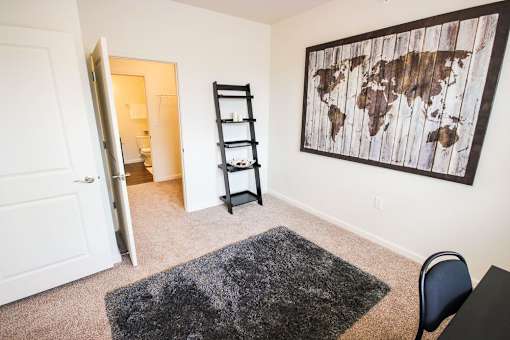 A room with a world map on the wall and a ladder leaning against it.
