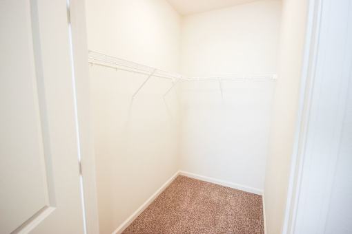 A small, empty room with a carpeted floor.