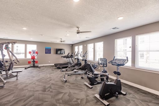 The gym at Swiftwater Luxury apartments with exercise equipment