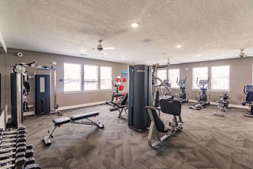 fitness center with a weight machine and a bench at Swiftwater apartments in Port Charlotte, FL