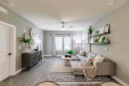 a living room with a couch and a table at Vantage Luxury Apartments in Cape Coral, Fl