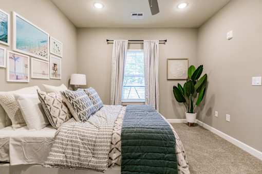 an empty bedroom with a bed and a window