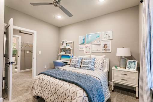a bedroom with a bed and a ceiling fan