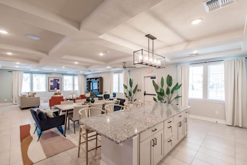 an open kitchen and living room with a granite counter top in swiftwater's clubhouse in port charlotte