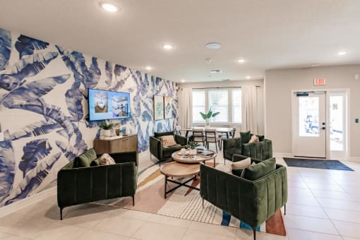 a living room with couches and chairs and a wall mural
