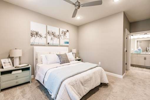 a bedroom with a bed and a ceiling fan