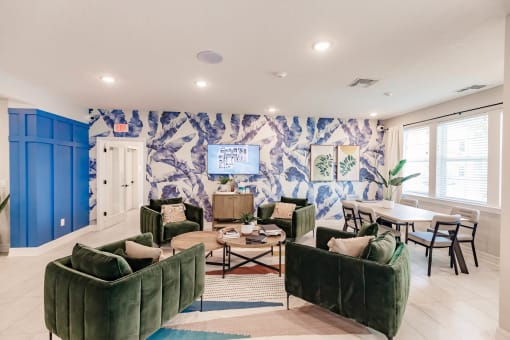 a living room with green couches and chairs and a table with chairs at Swiftwater apartments in Port Charlotte, FL