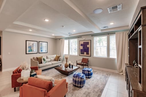 a living room with couches and chairs and a rug at Swiftwater Luxury apartments in Port Charlotte, FL