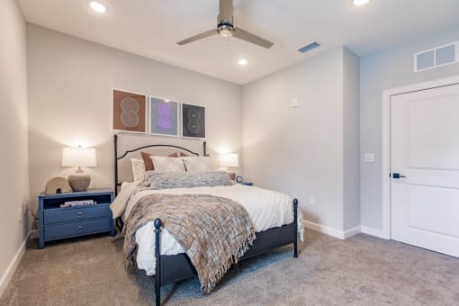 a bedroom with a bed and a ceiling fan at  a living room with tables and chairs and a ceiling fan at Swiftwater apartments in Port Charlotte, FL