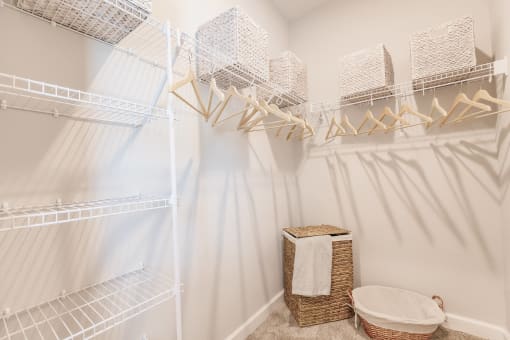 a walk in closet with a white shower and a basket on the floor at  a living room with tables and chairs and a ceiling fan at Swiftwater apartments in Port Charlotte, FL