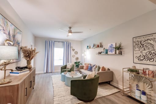 a living room with furniture and a ceiling fan at  a living room with tables and chairs and a ceiling fan at Swiftwater Luxury apartments in Port Charlotte, FL