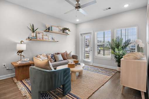 A living room with a grey couch and a wooden table.