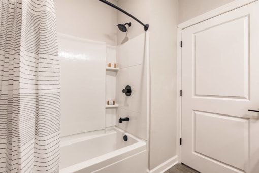 a bathroom with a shower and a tub and a shower curtain at swiftwater luxury apartments in port charlotte, fl