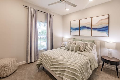 a bedroom with a bed and a ceiling fan at  a living room with tables and chairs and a ceiling fan at Swiftwater apartments in Port Charlotte, FL