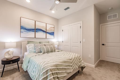 a bedroom with a bed and a ceiling fan at swiftwater luxury apartments in port charlotte, fl