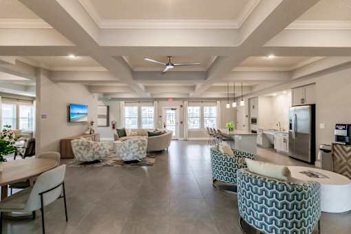 community lounge area with chairs and tables at Vantage Luxury Apartments in  Cape Coral, FL