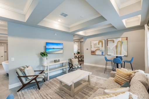 a living room with a tv, a couch and coffee table